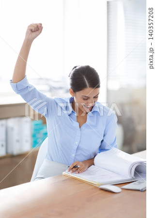 Excited, business woman and fist pump with documents for winning, achievement or good news at office. Happy female person or employee with smile and paperwork in satisfaction for success or promotion Excited, business woman and fist pump with documents for winning, achievement or good news at office. Happy female person or employee with smile and paperwork in satisfaction for success or promotion 140357208
