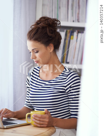 Coffee, typing and woman in home office with laptop, thinking and online job for business networking. Freelance, remote work and girl at table with computer for communication, email and copywriting. 140357214