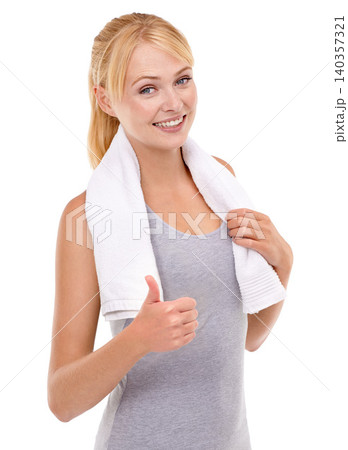 Woman, training and thumbs up with towel in studio for sport, motivation and exercise for wellness. Female person, smile and hand gesture for support, success and good workout on white background 140357321