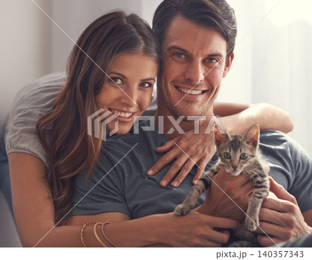Couple, kitten and portrait in home on sofa with hug for love, bonding or care for pet in living room. People, man and woman with kindness, embrace or pride for baby cat in lounge for animal adoption Couple, kitten and portrait in home on sofa with hug for love, bonding or care for pet in living room. People, man and woman with kindness, embrace or pride for baby cat in lounge for animal adoption 140357343