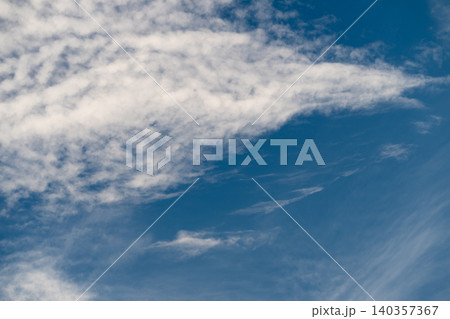 Sky moving swiftly. Expansive azure sky featuring drifting cirrus strands and flowing clouds. Open sky in shades of blue with sweeping wispy cloud lines and windcarved shapes Sky moving swiftly. Expansive azure sky featuring drifting cirrus strands and flowing clouds. Open sky in shades of blue with sweeping wispy cloud lines and windcarved shapes 140357367