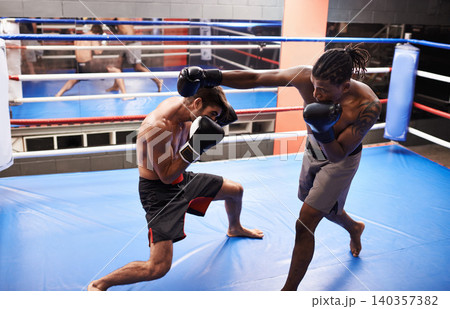 Men, fighting and boxing ring with punch for competition in gym for endurance development, performance or training. Male people, gear and combat sport together for cardio battle, defence or practice 140357382