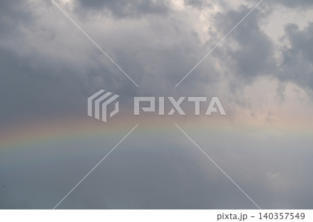 Colorful calming scene. Bright hues amidst gentle rain. Colorful sky over tranquil rainy landscape. Vibrant spectrum appears through brooding clouds with gentle reflections Colorful calming scene. Bright hues amidst gentle rain. Colorful sky over tranquil rainy landscape. Vibrant spectrum appears through brooding clouds with gentle reflections 140357549