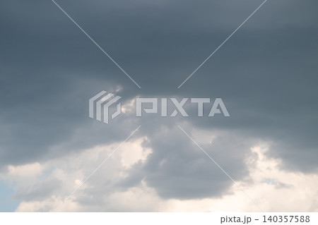 Stormy sky tension. Gray clouds signal impending storm. Dark clouds foretell approaching heavy rainfall. Overcast skies with subdued colors hint at oncoming storm activity 140357588