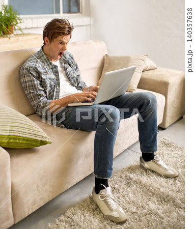 Remote work, stress and man screaming at laptop on sofa with glitch, mistake or 404 at home. Freelance, anger or male telework consultant frustrated by connection, fail or deadline disaster in house 140357638