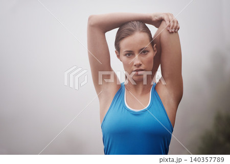 Portrait, fitness and woman stretching outdoor, wellness or sports on mockup space with fog. Face, serious person or warm up arms in nature with mist for exercise, training or workout for body health 140357789