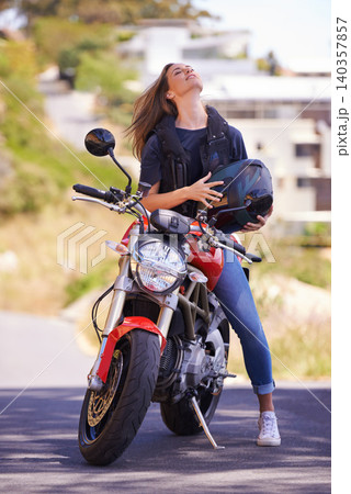 Woman, motorcycle and relax with helmet in city for ride, road trip or outdoor sightseeing in nature. Extreme female person, biker or rider chilling on motorbike or vehicle for transport or journey 140357857