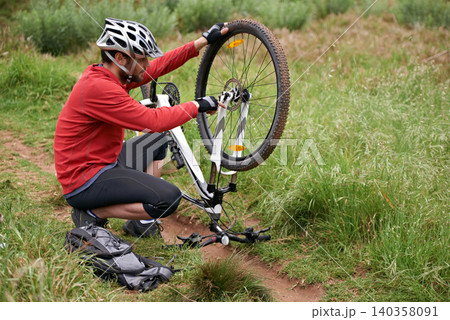 Exercise, bike and fixing wheel with man cyclist in countryside for sports, hobby or cardio training. Fitness, cycling or tyre puncture with young athlete and bicycle outdoor in nature for workout Exercise, bike and fixing wheel with man cyclist in countryside for sports, hobby or cardio training. Fitness, cycling or tyre puncture with young athlete and bicycle outdoor in nature for workout 140358091