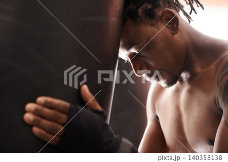 Boxing, fatigue and black man with punching bag in gym for challenge, fight and competition training. Power, muscle and exhausted champion boxer at workout with tired face, thinking and sports club. Boxing, fatigue and black man with punching bag in gym for challenge, fight and competition training. Power, muscle and exhausted champion boxer at workout with tired face, thinking and sports club. 140358138