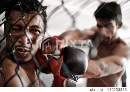 Punch, pain and men sparring in cage for kickboxing competition, challenge and fitness with fight in gym. Boxing match, strong fighter and knockout with exercise, practice or power in battle together Punch, pain and men sparring in cage for kickboxing competition, challenge and fitness with fight in gym. Boxing match, strong fighter and knockout with exercise, practice or power in battle together 140358226