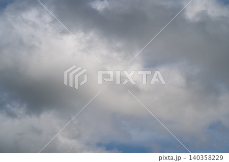 Gentle morning clouds. Serene dawn sky with soft haze. Early morning low clouds create peaceful atmosphere. Calm stratus clouds at sunrise evoke tranquility and natural beauty 140358229