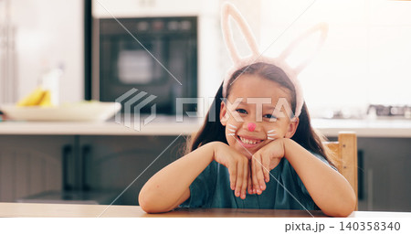 Girl, child and bunny ears for portrait in home to smile for culture, holiday or festive celebration. Kid, face paint and art for rabbit, Easter and happy for creativity, play or mask in family house 140358340