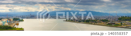 Kanazawa, Japan - Oct 6 2024, A panoramic aerial view of Kanazawa and Kanazawa Port, with the bay in the foreground and mountains in the background, on a cloudy day, Kanazawa, Japan Kanazawa, Japan - Oct 6 2024, A panoramic aerial view of Kanazawa and Kanazawa Port, with the bay in the foreground and mountains in the background, on a cloudy day, Kanazawa, Japan 140358357
