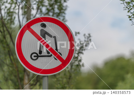 No electric scooters sign on roadside with blurred trees No electric scooters sign on roadside with blurred trees 140358573