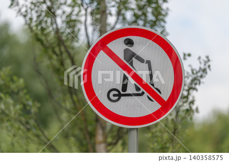 No electric scooter sign on pole near birch trees 140358575