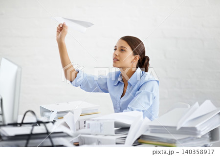 Corporate, businesswoman and paper plane at desk, sitting and thinking while working. Employee and paperwork with files in professional workspace, procrastination and avoid with distraction game Corporate, businesswoman and paper plane at desk, sitting and thinking while working. Employee and paperwork with files in professional workspace, procrastination and avoid with distraction game 140358917