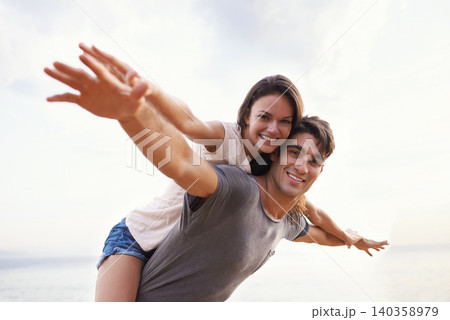Couple, beach and piggyback with freedom, smile and nature with travel and date for relationship. Man, woman and indonesia sea for adventure, vacation and tropical holiday with sunshine and portrait Couple, beach and piggyback with freedom, smile and nature with travel and date for relationship. Man, woman and indonesia sea for adventure, vacation and tropical holiday with sunshine and portrait 140358979