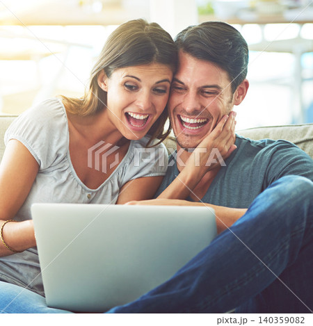 Happy couple, laptop and surprise with good news for winning or online giveaway in living room at home. Excited man or woman with smile on computer in celebration for promo, deal or discount at house 140359082