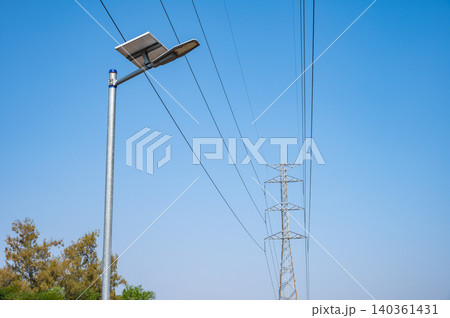 A light pole with solar panels against blue sky. When no cabling or infrastructure for lighting is available, light poles with solar panels are the solution. A light pole with solar panels against blue sky. When no cabling or infrastructure for lighting is available, light poles with solar panels are the solution. 140361431