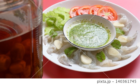 shrimp in fish sauce with Thai spicy seafood dipping sauce on white plate and umeshu 140361745