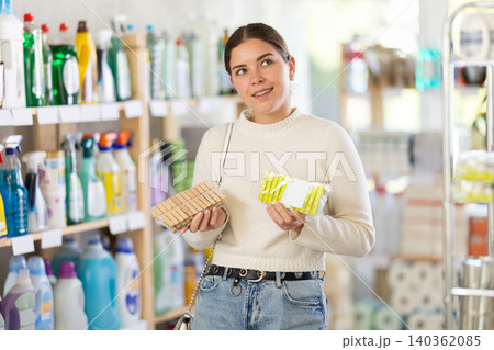 woman chooses clothespins for her home woman chooses clothespins for her home 140362085