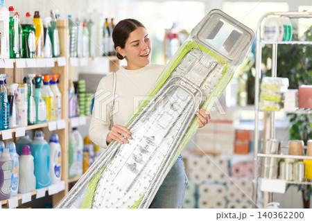 Woman choosing an ironing board 140362200