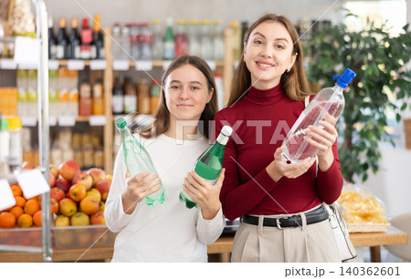 Mother and daughter choose soda Mother and daughter choose soda 140362601