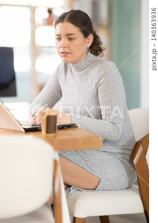 Working in modern office - businesswoman working on laptop Working in modern office - businesswoman working on laptop 140363936