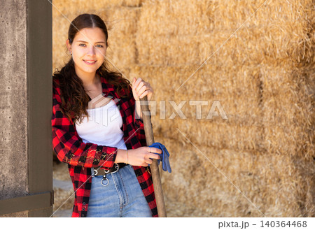 Woman posing at straw storage on farm Woman posing at straw storage on farm 140364468