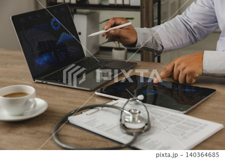 Business intelligence analytics dashboard displayed on laptop and tablet in healthcare office. Data visualization, KPI monitoring, financial reporting, digital transformation, performance analysis and Business intelligence analytics dashboard displayed on laptop and tablet in healthcare office. Data visualization, KPI monitoring, financial reporting, digital transformation, performance analysis and 140364685
