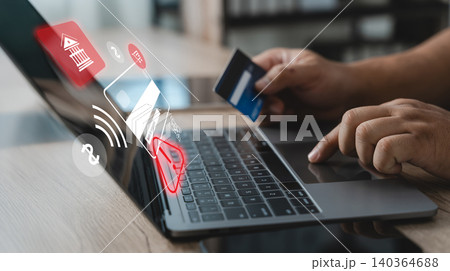 Person holding a credit card while using a laptop with security alert interface, illustrating online payment fraud detection, transaction monitoring, cybersecurity protection and digital banking risk Person holding a credit card while using a laptop with security alert interface, illustrating online payment fraud detection, transaction monitoring, cybersecurity protection and digital banking risk 140364688