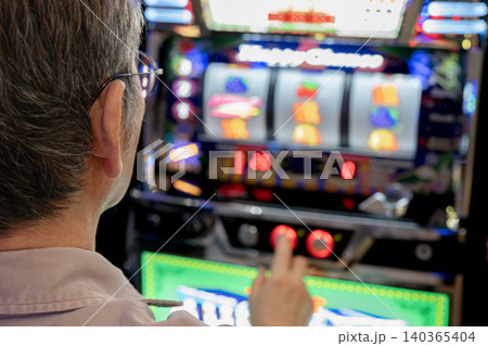 スロットマシンを遊戯する男性 スロットマシンを遊戯する男性 140365404