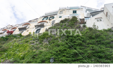 Facades of famous town of Amalfi, located on the Amalfi Coast, with its azure sea and beautiful colorful cliffside houses. Facades of famous town of Amalfi, located on the Amalfi Coast, with its azure sea and beautiful colorful cliffside houses. 140365903