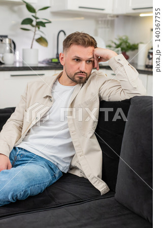 Young man after tough day shows tired mood silent stare and long sigh after many issues and stress Young man after tough day shows tired mood silent stare and long sigh after many issues and stress 140367755