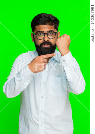 Indian man clenching fist in front showing power threat determination strong gesture chroma key 140367991