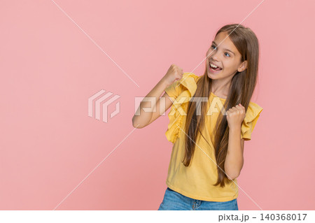 Child girl kid showing victory win gesture while happily and joyfully celebrating success with smile Child girl kid showing victory win gesture while happily and joyfully celebrating success with smile 140368017