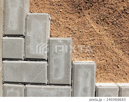 Paving stones being laid on sand for a new patio or walkway	 140368683