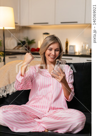 Adult woman reads smartphone app notification about jackpot win smiles celebrates big lottery news Adult woman reads smartphone app notification about jackpot win smiles celebrates big lottery news 140369021