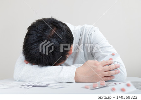 中年男性の体調不良、病気と大量の薬。悩む男性は複数の薬を試している 中年男性の体調不良、病気と大量の薬。悩む男性は複数の薬を試している 140369822