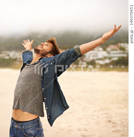 Happy man, beach and freedom with hands out for travel, adventure or outdoor sightseeing in nature. Excited male person with smile in satisfaction or happiness for holiday weekend on the ocean coast Happy man, beach and freedom with hands out for travel, adventure or outdoor sightseeing in nature. Excited male person with smile in satisfaction or happiness for holiday weekend on the ocean coast 140370451