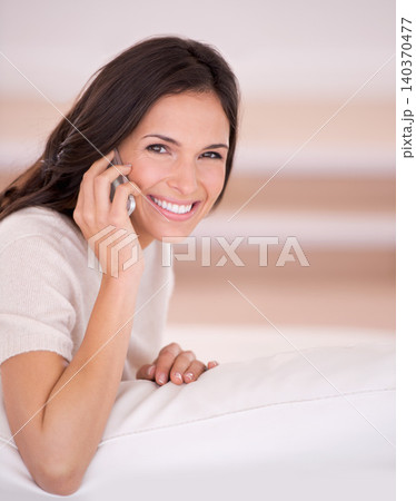 Woman, happy and portrait with phone on sofa with contact, conversation and relax in living room. Girl, person and smile with smartphone, mobile network and chat on lounge couch at house in Istanbul 140370477