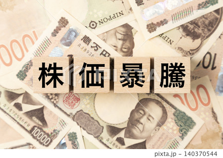 「株価暴騰」と書かれたブロックとたくさんの一万円札 「株価暴騰」と書かれたブロックとたくさんの一万円札 140370544