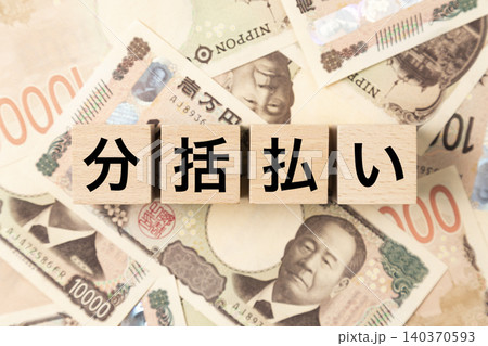「分割払い」と書かれたブロックとたくさんの一万円札 「分割払い」と書かれたブロックとたくさんの一万円札 140370593