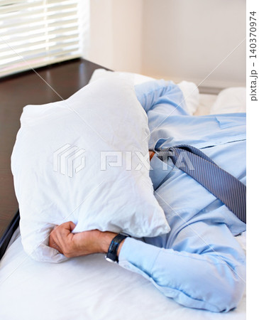Stress, pillow and tired with business man in bedroom for frustrated, fatigue and fear. Mistake, mental health and burnout with exhausted person in bed at home for overworked, sad and crisis 140370974