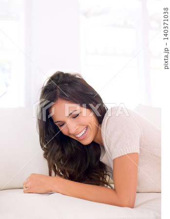 Portrait, laughing or happy woman on couch to relax in living room on holiday in a house or apartment. Lying down, sofa or funny person with smile or wellness on vacation break to rest in alone time Portrait, laughing or happy woman on couch to relax in living room on holiday in a house or apartment. Lying down, sofa or funny person with smile or wellness on vacation break to rest in alone time 140371038