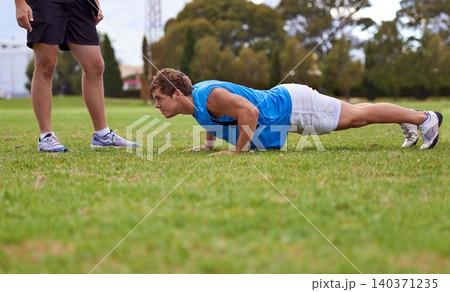 Men, push up and personal trainer on field for exercise with counting for stats, progress or development. Person, coach or mentor with inspection for balance, training or workout for health on grass 140371235