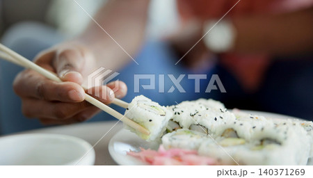 Hand, chopstick or sushi in home for lunch, Japanese cuisine or roll selection in living room. Hungry person, rice meal or pickled ginger on dish for appetizer, seafood catering or nutrition in house Hand, chopstick or sushi in home for lunch, Japanese cuisine or roll selection in living room. Hungry person, rice meal or pickled ginger on dish for appetizer, seafood catering or nutrition in house 140371269