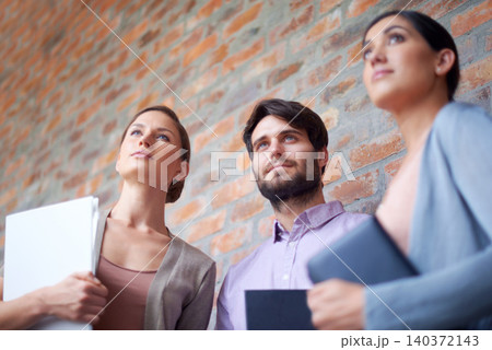 Business, colleagues and together while thinking of ideas for work project, collaboration and teamwork for workplace. Coworkers, employees and standing with vision for company, job and bottom view 140372143