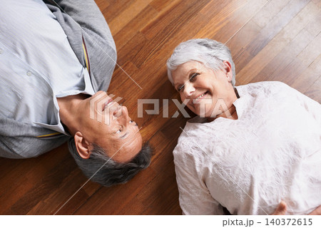 Smile, senior or happy couple on floor to relax in home living room for bonding or support in retirement. Above, old people or man lying down by an elderly woman for trust, peace or care in marriage 140372615