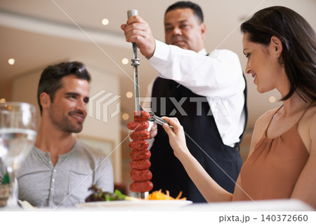 Couple, restaurant and date for eating, service and love for celebration on holiday. Woman, man and fine dining with luxury, smile and romance for vacation or marriage anniversary with gourmet meal 140372660